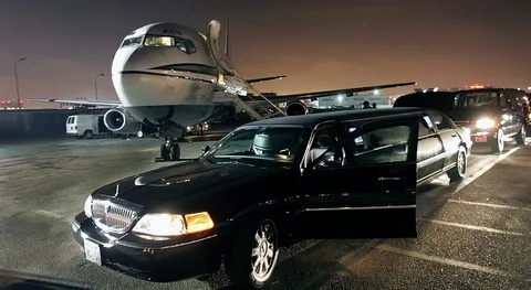 Airport Limo Service providing luxury airport transportation with a chauffeur-driven limousine near a private jet.